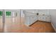 Basement bar area with white cabinets and wood-look flooring at 3332 Saint John Dr, East Point, GA 30344
