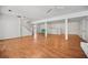 Spacious finished basement with wood floors, stairs and a vintage brick bar at 3332 Saint John Dr, East Point, GA 30344