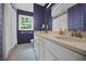 Bathroom with dual sink vanity, large mirror, and window at 3332 Saint John Dr, East Point, GA 30344