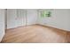This bedroom has light wood floors, white walls, and a window at 3332 Saint John Dr, East Point, GA 30344