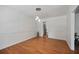 Dining room featuring a modern light fixture and hardwood flooring with access to kitchen at 3332 Saint John Dr, East Point, GA 30344