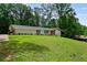 Beautiful front yard and exterior of home with lush green lawn at 3332 Saint John Dr, East Point, GA 30344