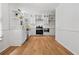 Modern kitchen featuring white cabinetry, subway tile backsplash, stainless steel appliances, and hardwood floors at 3332 Saint John Dr, East Point, GA 30344