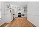 Well-lit kitchen boasts modern white cabinets, stainless steel appliances, and hardwood floors at 3332 Saint John Dr, East Point, GA 30344