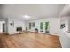 Spacious living room with hardwood floors, white fireplace, built-ins, and glass doors to the exterior at 3332 Saint John Dr, East Point, GA 30344