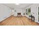 Cozy living room showcasing a brick fireplace, built-in shelving, and hardwood flooring at 3332 Saint John Dr, East Point, GA 30344