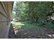 Lush backyard featuring a large grassy area and mature trees offering shade and privacy at 3429 Timbercreek Dr, Lawrenceville, GA 30044