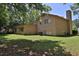 Exterior shot showing a spacious backyard with lush green grass and mature trees at 3429 Timbercreek Dr, Lawrenceville, GA 30044