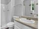 Bright bathroom featuring a walk-in shower, toilet, and vanity with a sink at 3429 Timbercreek Dr, Lawrenceville, GA 30044