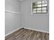 Bright bedroom featuring wood-look flooring, light-colored walls, and a sunny window at 3429 Timbercreek Dr, Lawrenceville, GA 30044