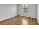 Bright bedroom featuring wood-look flooring, light-colored walls, and a window at 3429 Timbercreek Dr, Lawrenceville, GA 30044