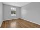 This bedroom boasts light-colored walls, wood-look flooring, and a bright window overlooking trees at 3429 Timbercreek Dr, Lawrenceville, GA 30044