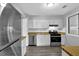 Bright kitchen features white cabinets, laminate countertops, and stainless steel appliances at 3429 Timbercreek Dr, Lawrenceville, GA 30044