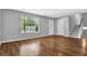 Open living room featuring hardwood floors, a window, and a staircase for easy access at 3429 Timbercreek Dr, Lawrenceville, GA 30044
