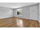Bright living room featuring wood-look floors, white walls, and a large window for natural light at 3429 Timbercreek Dr, Lawrenceville, GA 30044