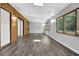Large living room with hardwood flooring, wood paneling and multiple windows for natural lighting at 3429 Timbercreek Dr, Lawrenceville, GA 30044