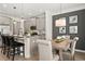 Open kitchen and dining area, featuring a breakfast bar and gray accent wall with artwork at 84 Ravencliff Dr # 84, Austell, GA 30168