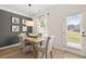 Cozy dining area with natural light, wood floors, gray accent wall, and a stylish light fixture at 84 Ravencliff Dr # 84, Austell, GA 30168