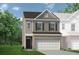 Charming two-story home featuring a brick-accented front and attached two-car garage at 84 Ravencliff Dr # 84, Austell, GA 30168