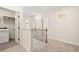 Bright hallway with nine-foot ceilings, wooden banister and the laundry room door ajar at 84 Ravencliff Dr # 84, Austell, GA 30168