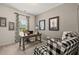 Well-lit home office with modern desk, chair, decor, and checkered armchairs at 84 Ravencliff Dr # 84, Austell, GA 30168
