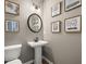 Elegant powder room with pedestal sink, modern fixtures, and stylish wall decor at 84 Ravencliff Dr # 84, Austell, GA 30168