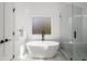 Bathroom features a modern tub, walk-in shower with black hardware at 907 Edgewood Ave Ne, Atlanta, GA 30307