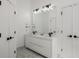 Bathroom with a dual sink vanity, modern mirror, and lighting at 907 Edgewood Ave Ne, Atlanta, GA 30307