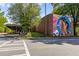 Exterior shot of colorful mural on a building, covered walkway, and crosswalks at 907 Edgewood Ave Ne, Atlanta, GA 30307