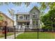 Stylish two-story home featuring a fenced yard and a cozy front porch at 907 Edgewood Ave Ne, Atlanta, GA 30307