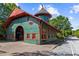 Exterior shot of a green and red building with a domed tower, brick sidewalk, and street at 907 Edgewood Ave Ne, Atlanta, GA 30307