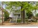 Charming two-story home with mature trees and flowering plants on the front lawn at 907 Edgewood Ave Ne, Atlanta, GA 30307