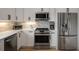 Bright kitchen featuring white cabinets, stainless steel appliances, and modern counters at 907 Edgewood Ave Ne, Atlanta, GA 30307