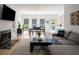 Open-concept living room with a fireplace, dining area, and access to the kitchen at 907 Edgewood Ave Ne, Atlanta, GA 30307
