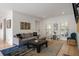 Inviting living room featuring a gray sofa, modern art, and abundant natural light at 907 Edgewood Ave Ne, Atlanta, GA 30307