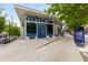 Trendy restaurant exterior with a bold blue door, large windows, and sleek benches outside at 907 Edgewood Ave Ne, Atlanta, GA 30307