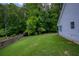 Lush backyard featuring a large grassy area, mature trees, and a wooden fence, offering privacy at 175 Prince Ct, Hiram, GA 30141