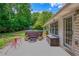 Backyard patio showcasing an outdoor seating set, a wooden storage bin, and a covered hot tub at 175 Prince Ct, Hiram, GA 30141