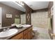 Bathroom with double sinks, large mirror, and shower/tub combo with patterned curtain at 175 Prince Ct, Hiram, GA 30141