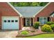 Charming home with a brick facade, two car garage and manicured front garden at 175 Prince Ct, Hiram, GA 30141