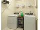 Functional laundry room equipped with a washer, dryer, and shelving for organization at 175 Prince Ct, Hiram, GA 30141