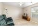 Cozy room with neutral walls and carpet, featuring a ceiling fan and natural light from a window at 175 Prince Ct, Hiram, GA 30141