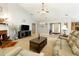 Open-concept living room with a fireplace, neutral carpet, and comfortable leather seating at 175 Prince Ct, Hiram, GA 30141