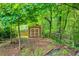 Backyard storage shed with double doors set amongst the trees at 175 Prince Ct, Hiram, GA 30141