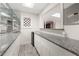 Basement bar with granite countertop, mini fridge, modern cabinetry and mirrored backsplash at 410 Glenmont Ct, Atlanta, GA 30350