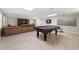 Basement with a pool table, leather couch, and tile flooring for leisure and entertainment at 410 Glenmont Ct, Atlanta, GA 30350