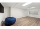 Finished basement with wood look flooring, glass block window and modern lighting at 410 Glenmont Ct, Atlanta, GA 30350