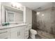 Bathroom featuring granite vanity, a modern shower with a glass door and tile walls at 410 Glenmont Ct, Atlanta, GA 30350