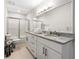 Bathroom with double vanity sinks, granite countertop and shower and toilet at 410 Glenmont Ct, Atlanta, GA 30350