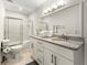 Bathroom with double vanity sinks, granite countertop and shower and toilet at 410 Glenmont Ct, Atlanta, GA 30350